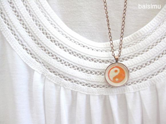 Yin yang. Round copper necklace handprinted in red